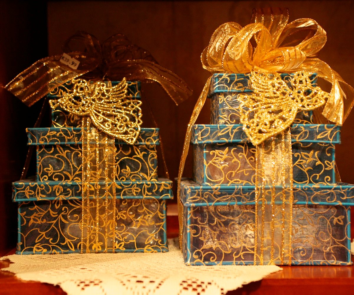 Stacked gift hampers tied with gold ribbon