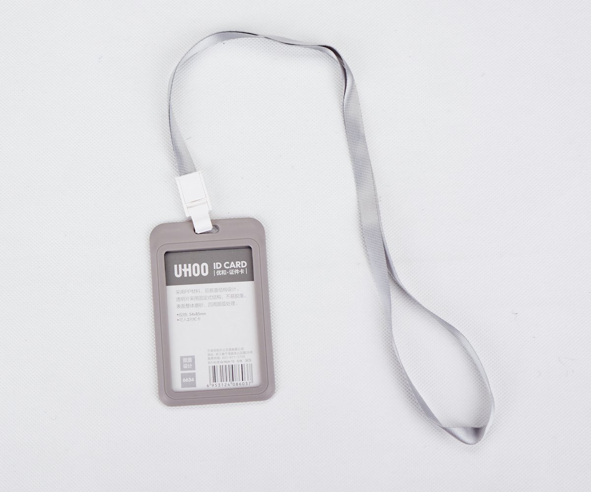 A printed lanyard holding a employee ID card