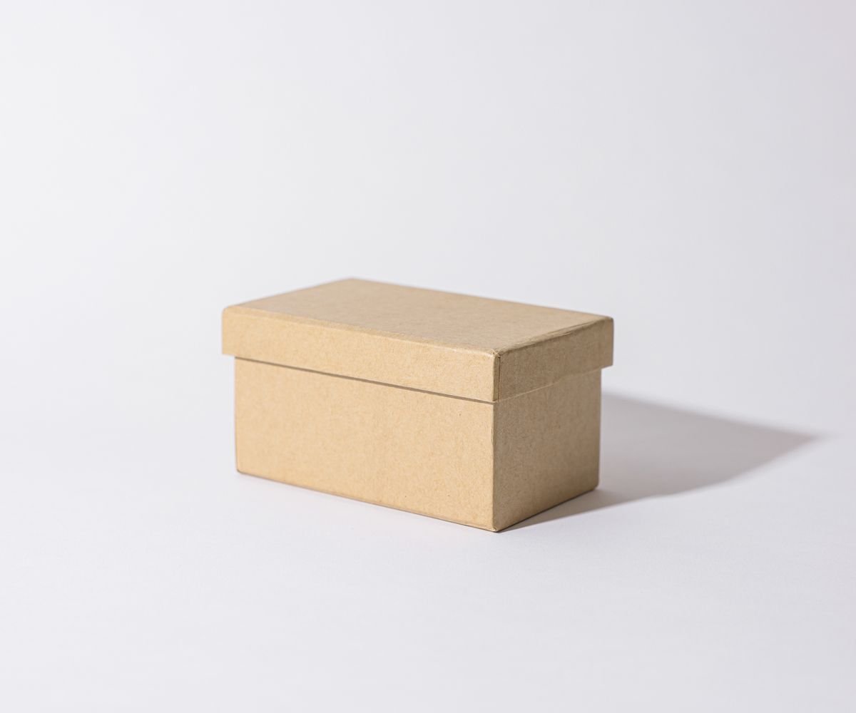 A clean kraft gift box photographed against a plain background